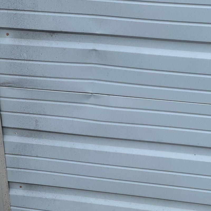 Metal siding panels with dents and damage marks