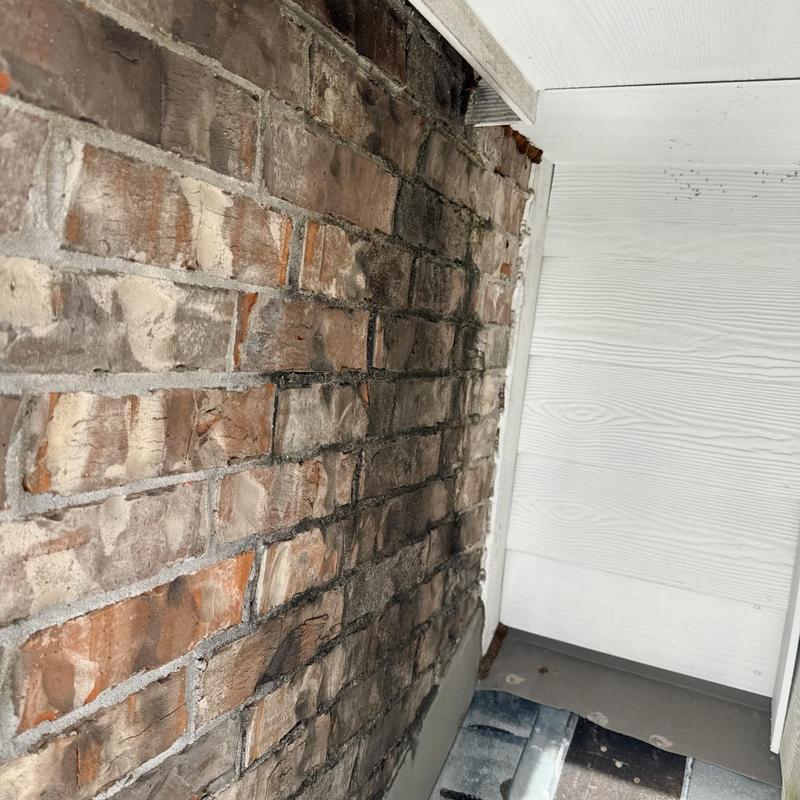 Wall flashing corner with siding and brick wall gap