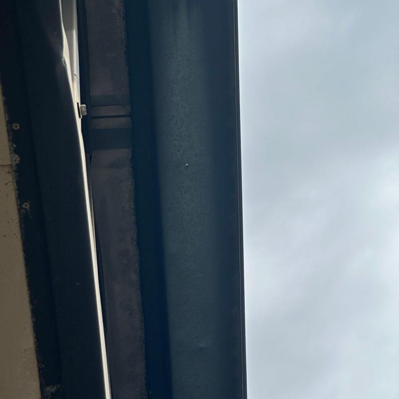 Commercial metal gutter showing surface wear and dents