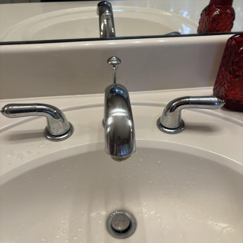 Bathroom sink faucet and handles with water flow Bathroom sink faucet and handles with water flow