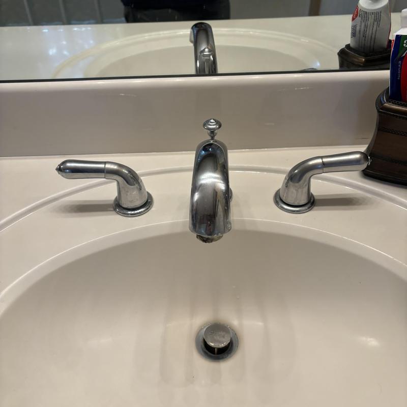 Bathroom sink faucet and handles close-up Bathroom sink faucet and handles close-up