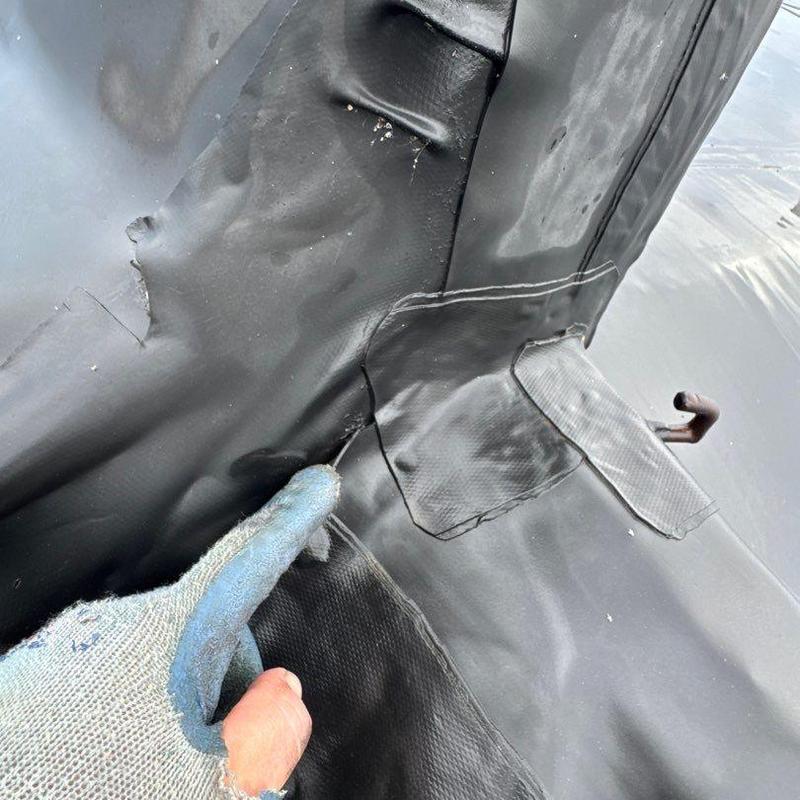 TPO roofing membrane with hail damage and patch repairs