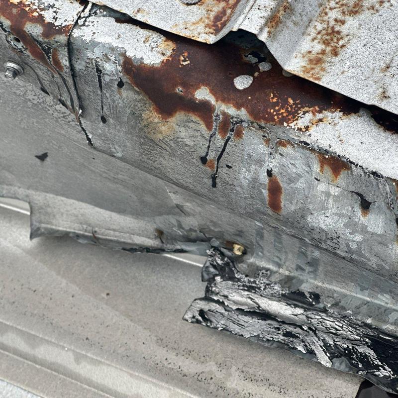 Metal roof flashing rust and damage close-up
