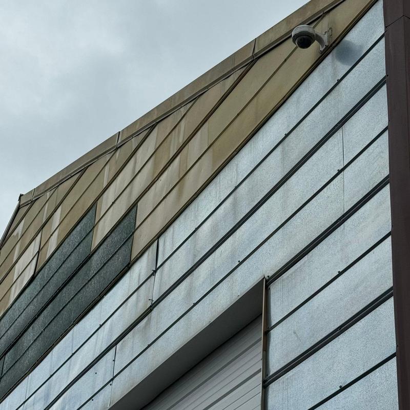 Commercial metal roofing with visible hail damage