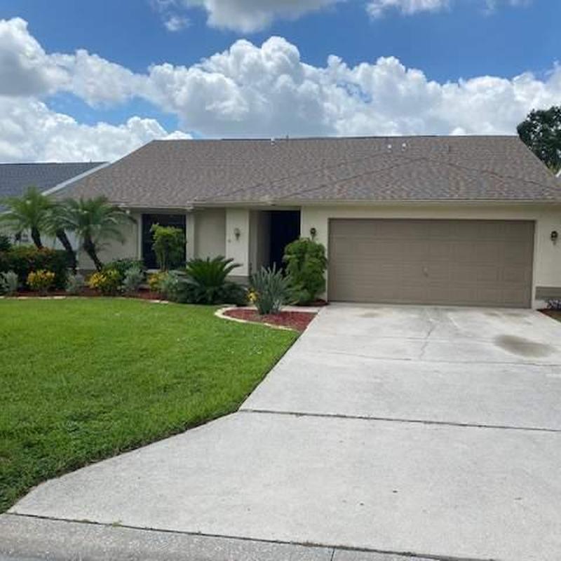 Shingle roof on residential home with driveway and lawn