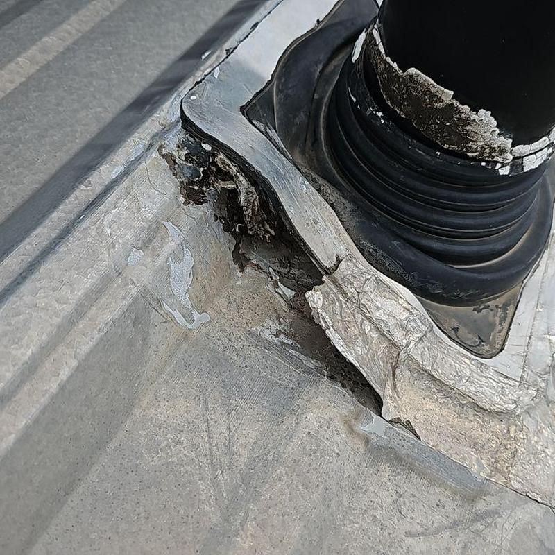 Metal roof pipe jack seal with damage and wear Metal roof pipe jack seal with damage and wear
