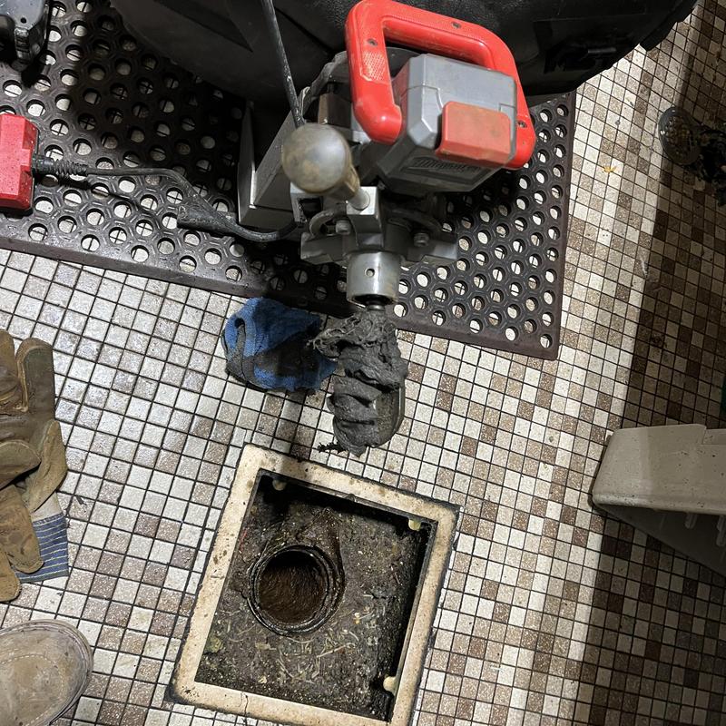 Drain line clog removal using motorized drain snake