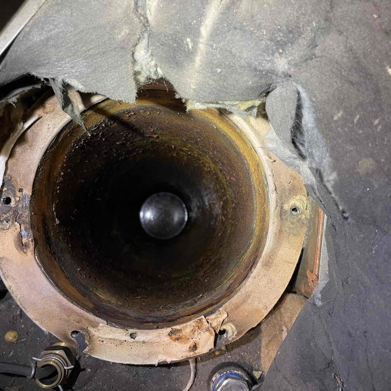 Water heater exhaust pipe inspection showing rust buildup