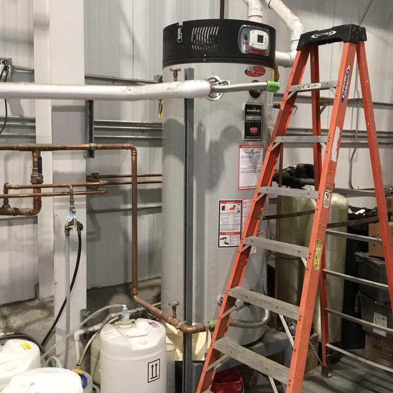 Water heater with burner assembly and exhaust inspection