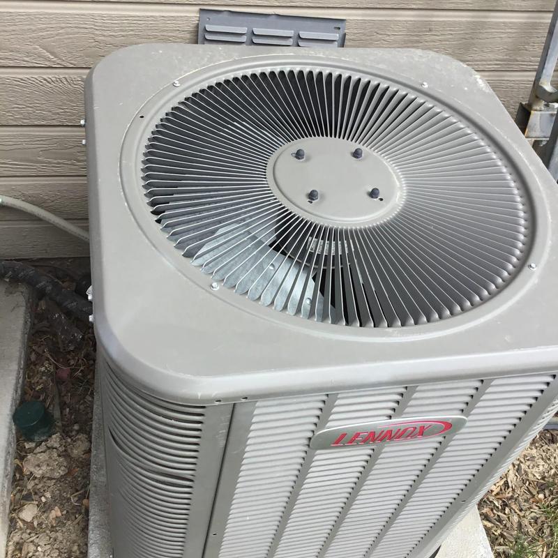 Lennox air conditioner condenser unit outside home