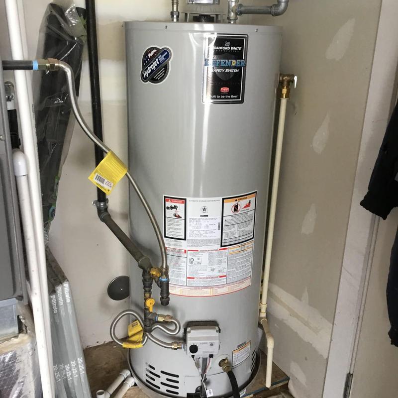Water heater with connected pipes and safety labels