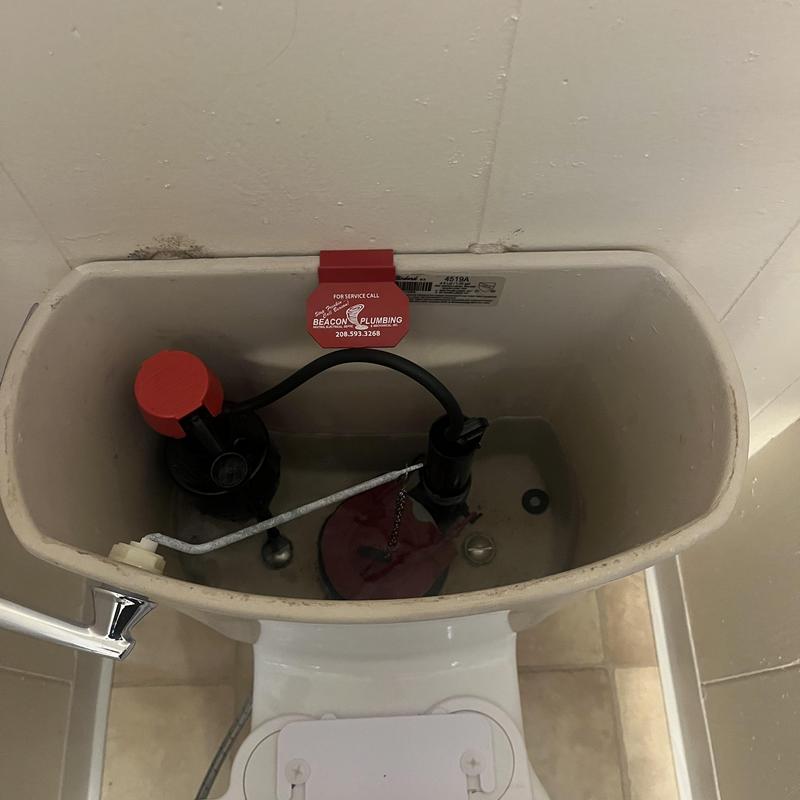 Toilet tank interior with flapper and fill valve components