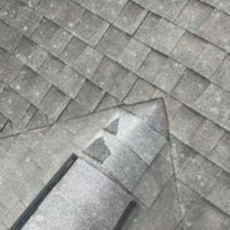Roof shingles with damaged and missing pieces