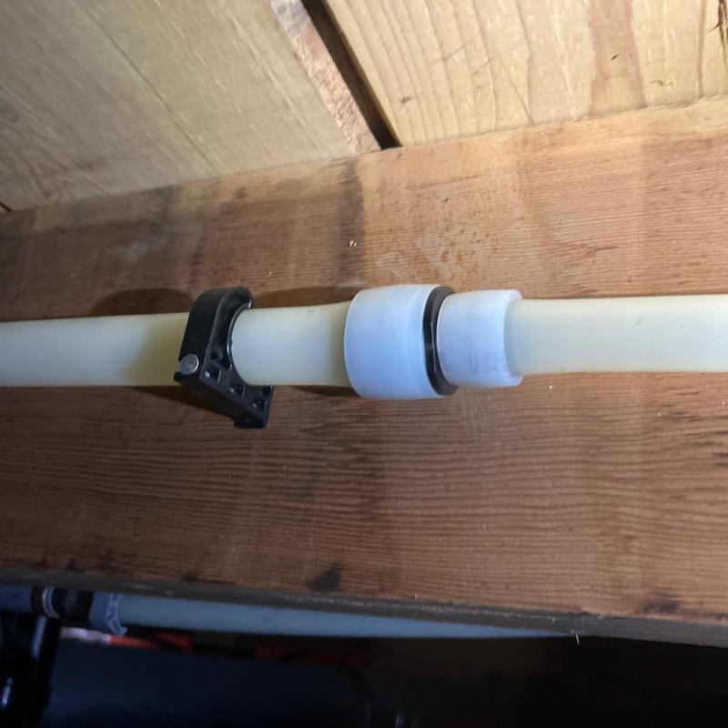 PEX plumbing pipe with compression fitting and clamp