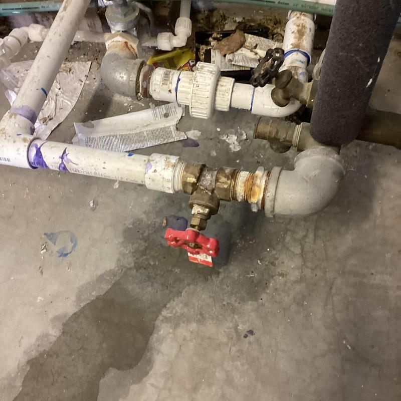 Corroded valve and PVC piping near pressure tank leak