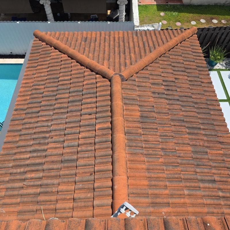 Aged tile roof replacement with ridge caps