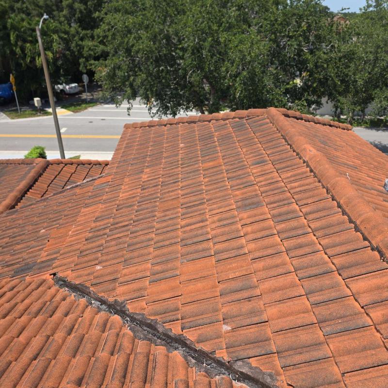 Tile roof with age-related damage and replacement site