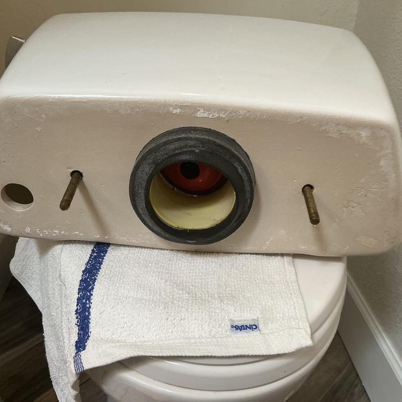 Toilet tank with gasket and bolt holes visible Toilet tank with gasket and bolt holes visible