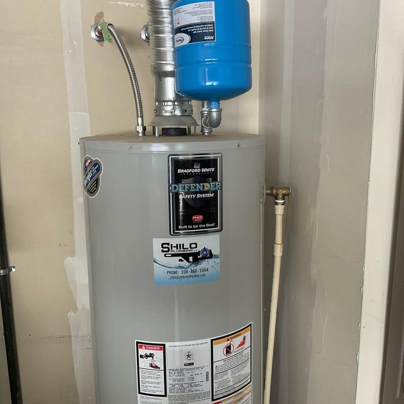 Water heater expansion tank above tank installation