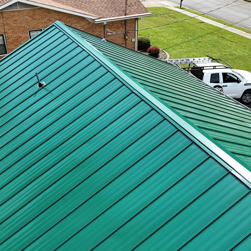 Green standing seam metal roof with ridge cap Green standing seam metal roof with ridge cap