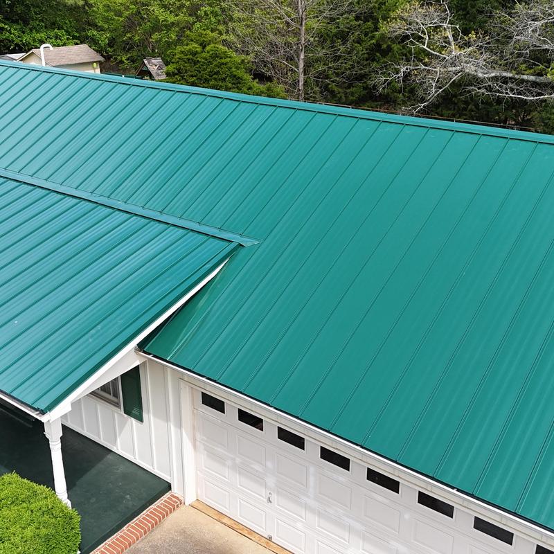 Green standing seam metal roof on residential house Green standing seam metal roof on residential house