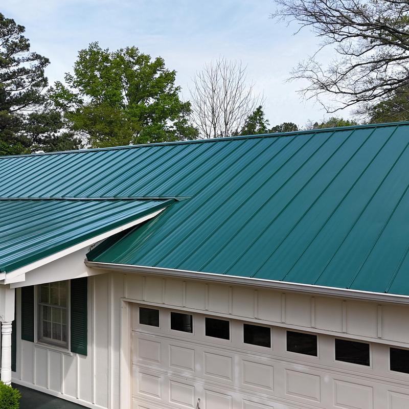 Green standing seam metal roof on residential home Green standing seam metal roof on residential home