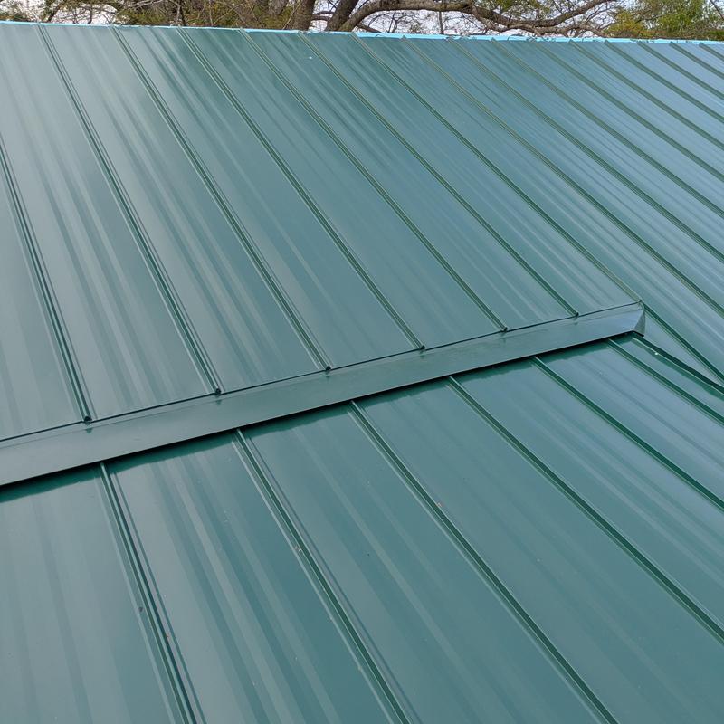 Green standing seam metal roof with ridge cap Green standing seam metal roof with ridge cap