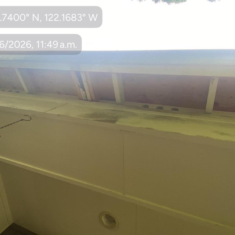 Eaves soffit board with water damage and gaps