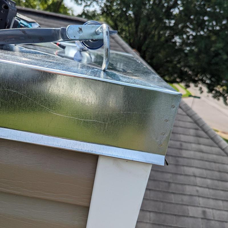 Metal gutter guard installation on roof edge