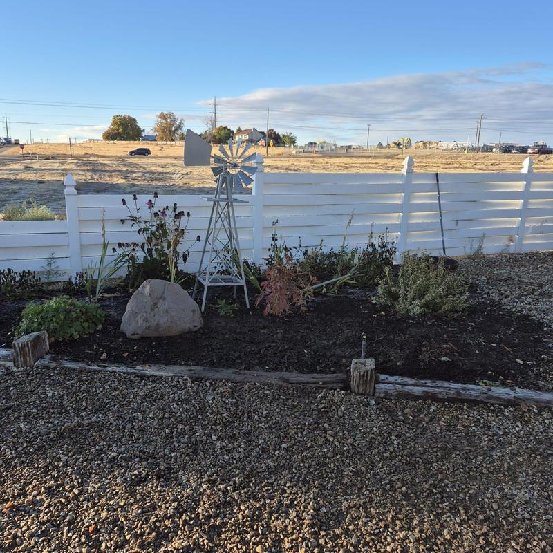 Irrigation valve area with ornamental windmill and plants