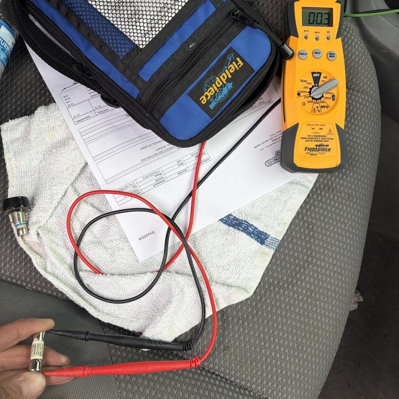 Electric fuse testing with multimeter on car seat