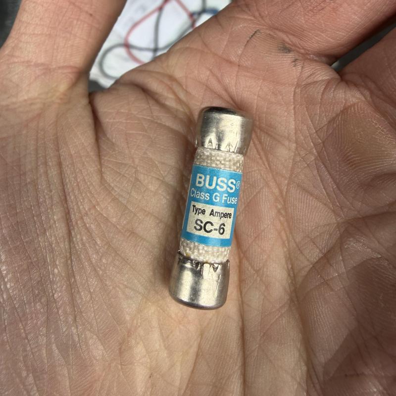 Class G fuse SC-6 held in hand for replacement