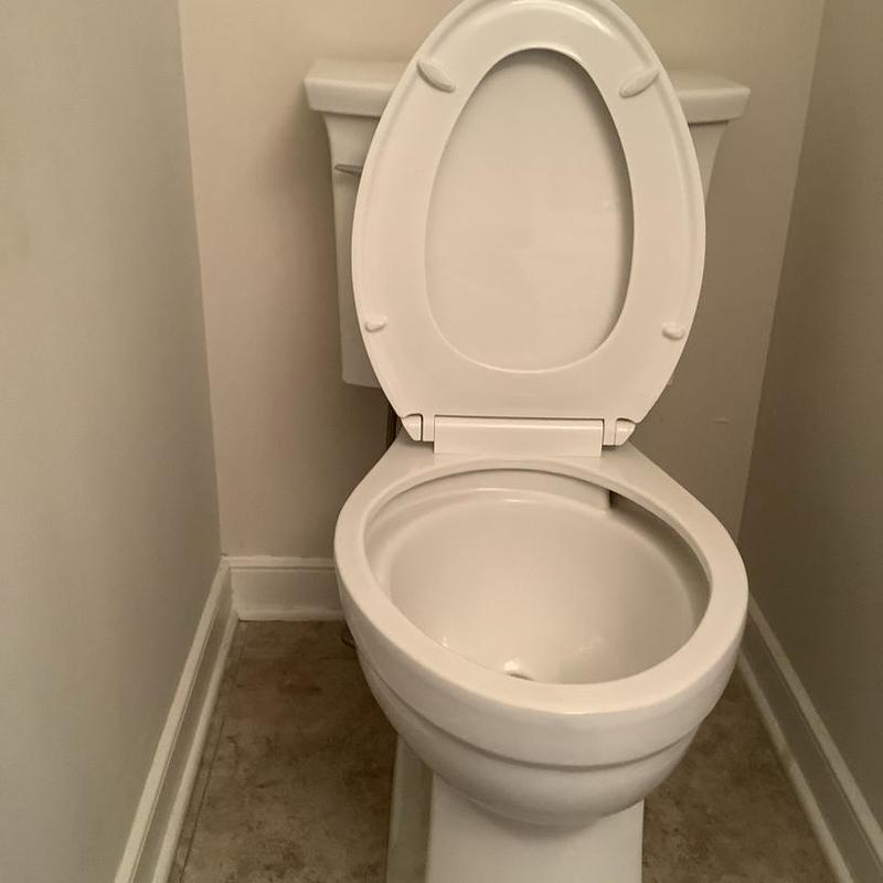 Toilet with open seat installed in home bathroom Toilet with open seat installed in home bathroom