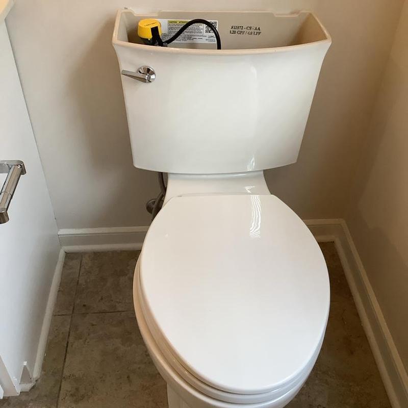Toilet tank with internal components installed in bathroom Toilet tank with internal components installed in bathroom