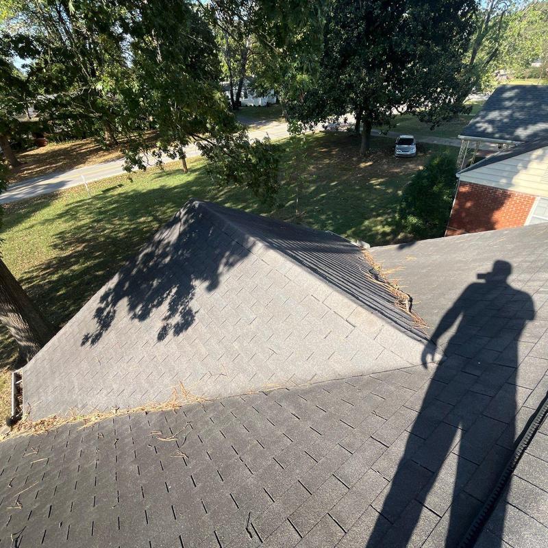 Roof shingles inspection showing hail damage and debris