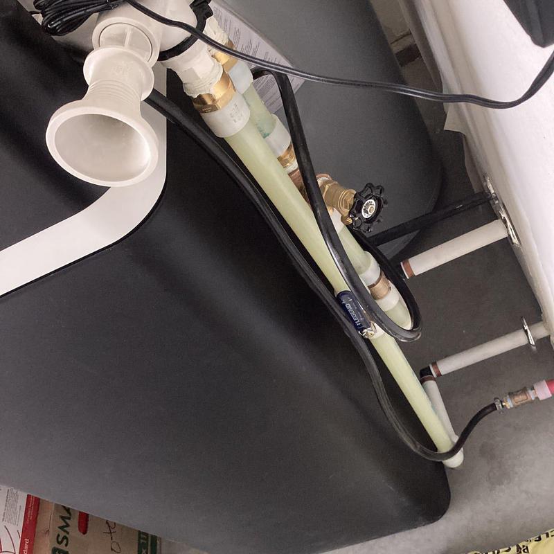 Water softener installation with pipes and valve setup