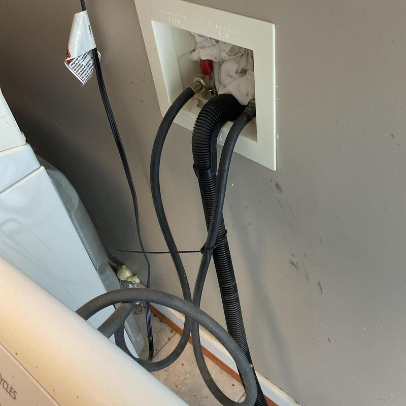 Washing machine box with water supply and drain hoses Washing machine box with water supply and drain hoses
