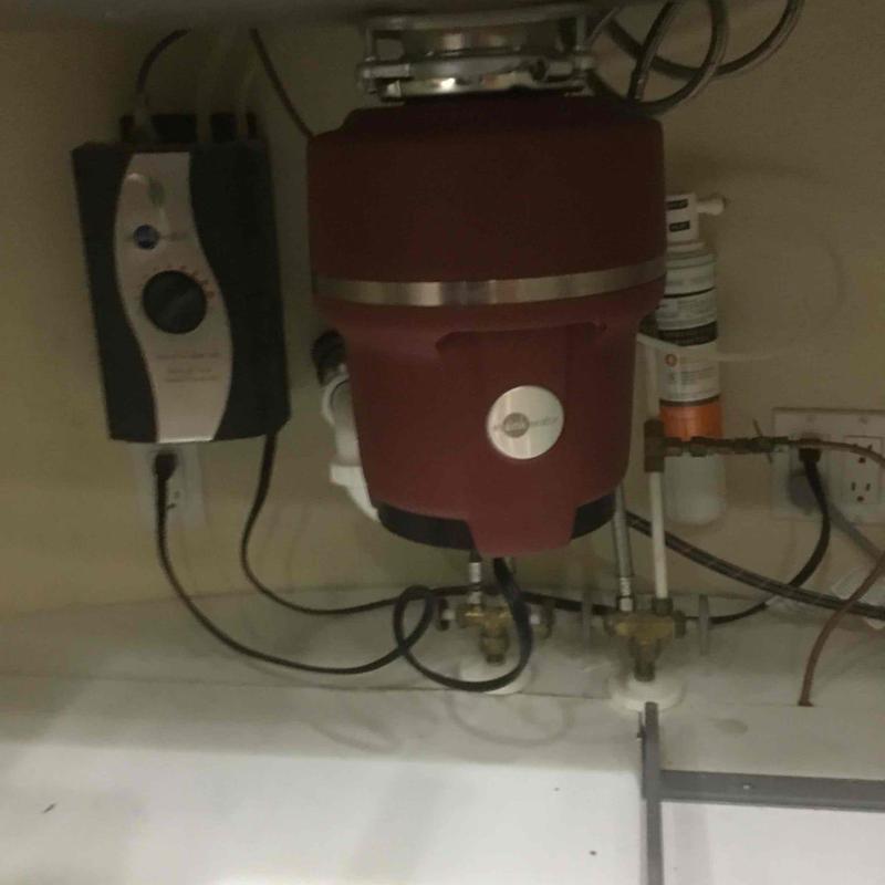 Kitchen garbage disposal installation under sink with plumbing