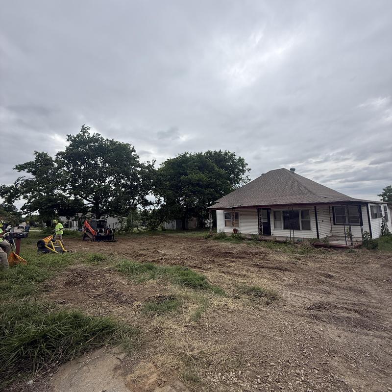 Storm-damaged tree removal near house and yard cleanup
