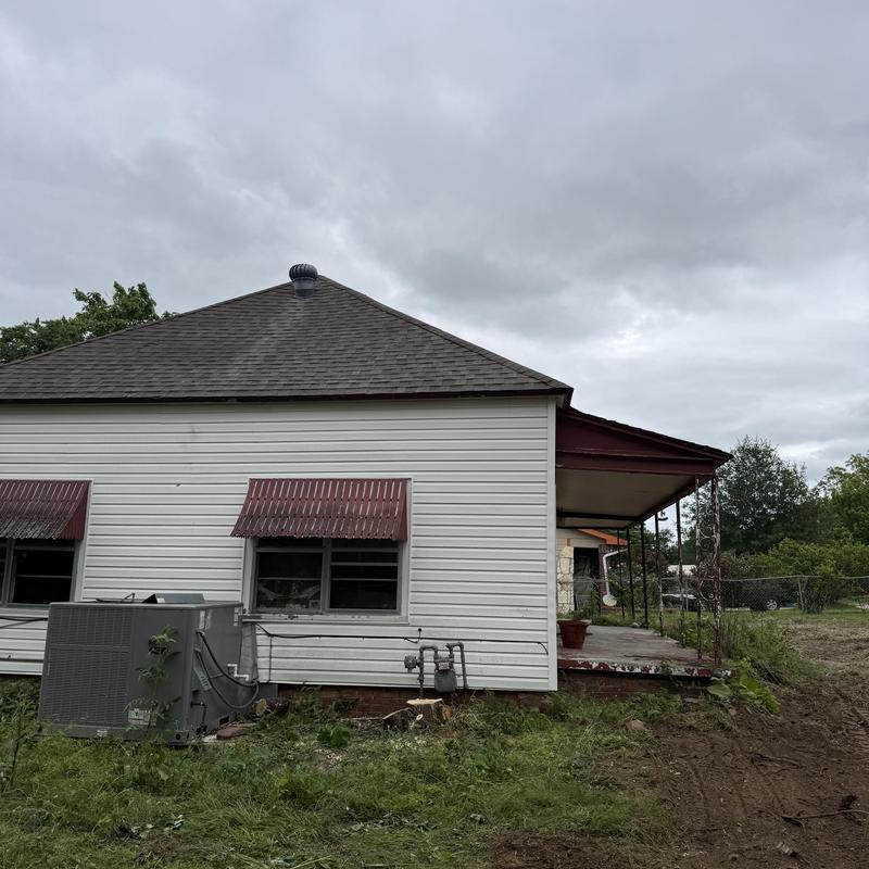 Air conditioning unit beside residential house exterior