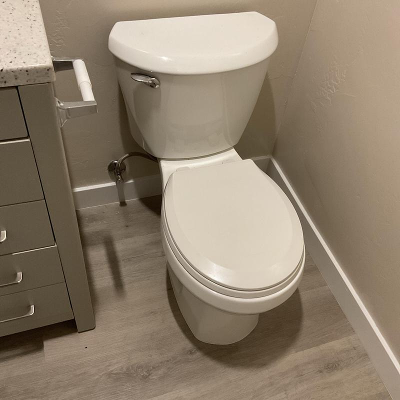 Toilet installation in residential bathroom corner