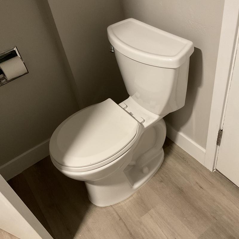 Toilet installation in residential bathroom corner
