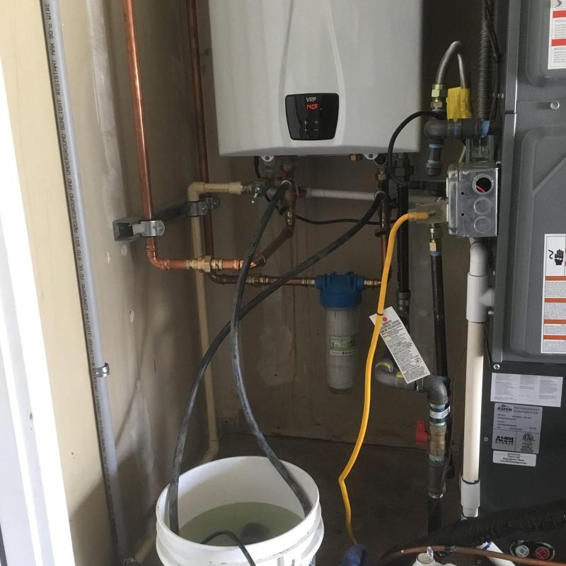 Tankless water heater descaling setup with bucket