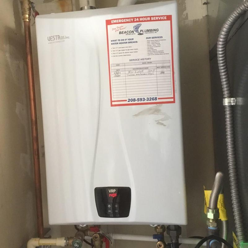 Tankless water heater with service history label