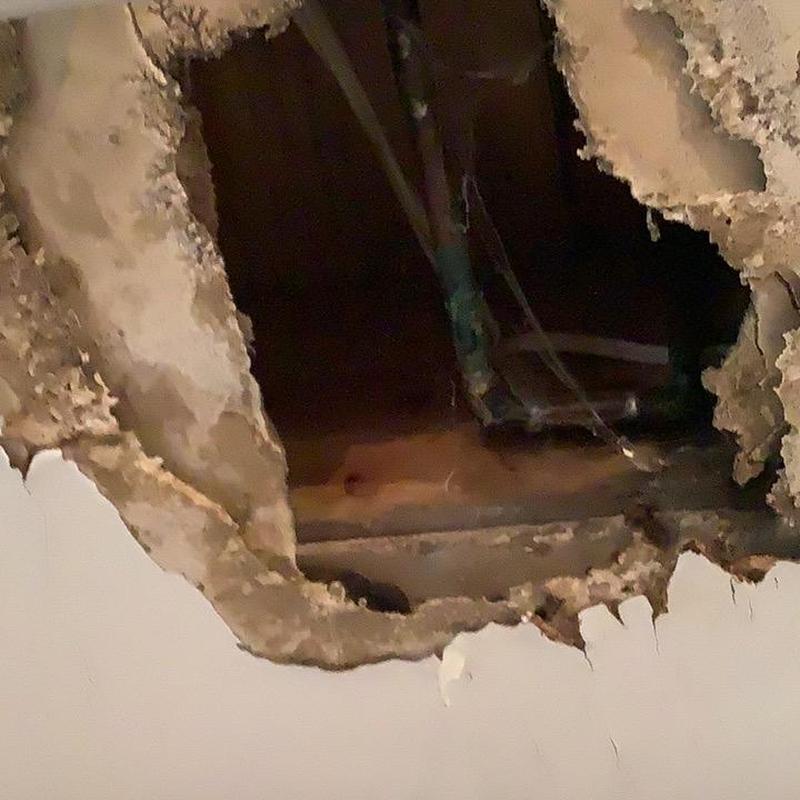 Copper waterline with ceiling hole from leak damage Copper waterline with ceiling hole from leak damage