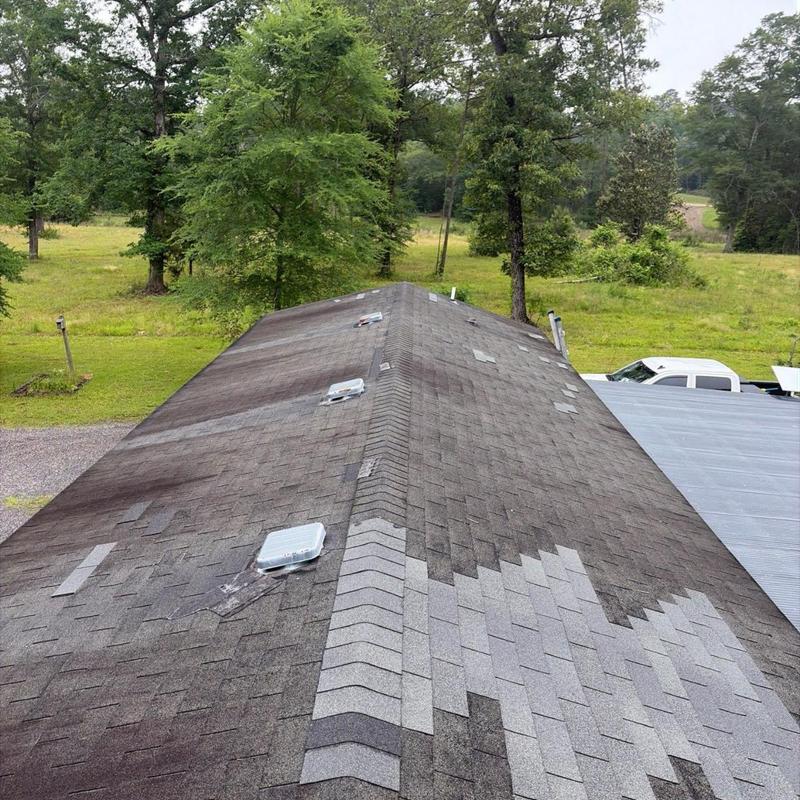 Asphalt shingle roof with storm damage patches in Florence, MS