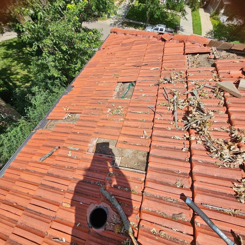 Historic clay tile roof with wind storm damage