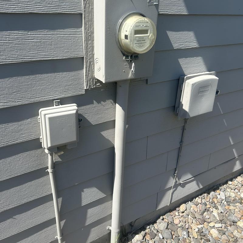 Electric meter and outdoor electrical boxes on siding