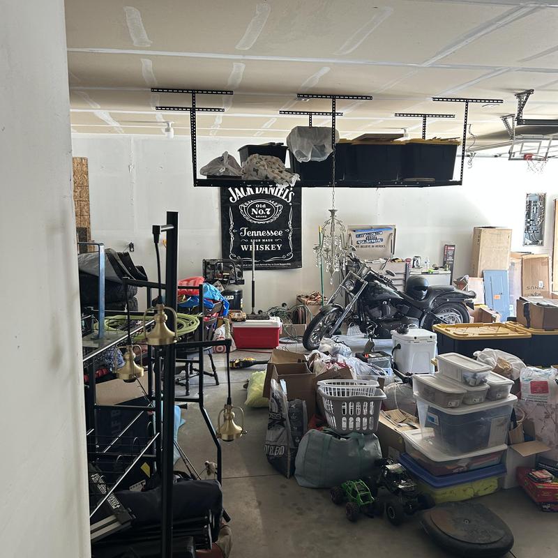 Motorcycle in cluttered garage with storage bins