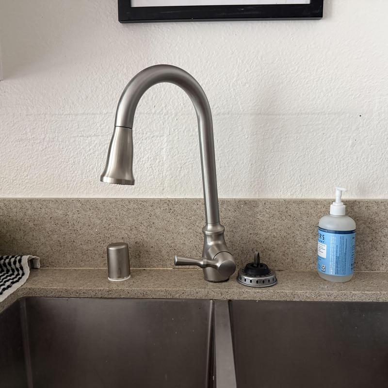 Kitchen faucet with spray head on granite countertop